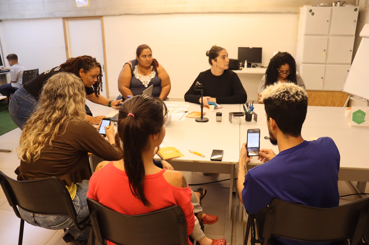 participantes sentados  ao redor da mesa realizando exercícios.